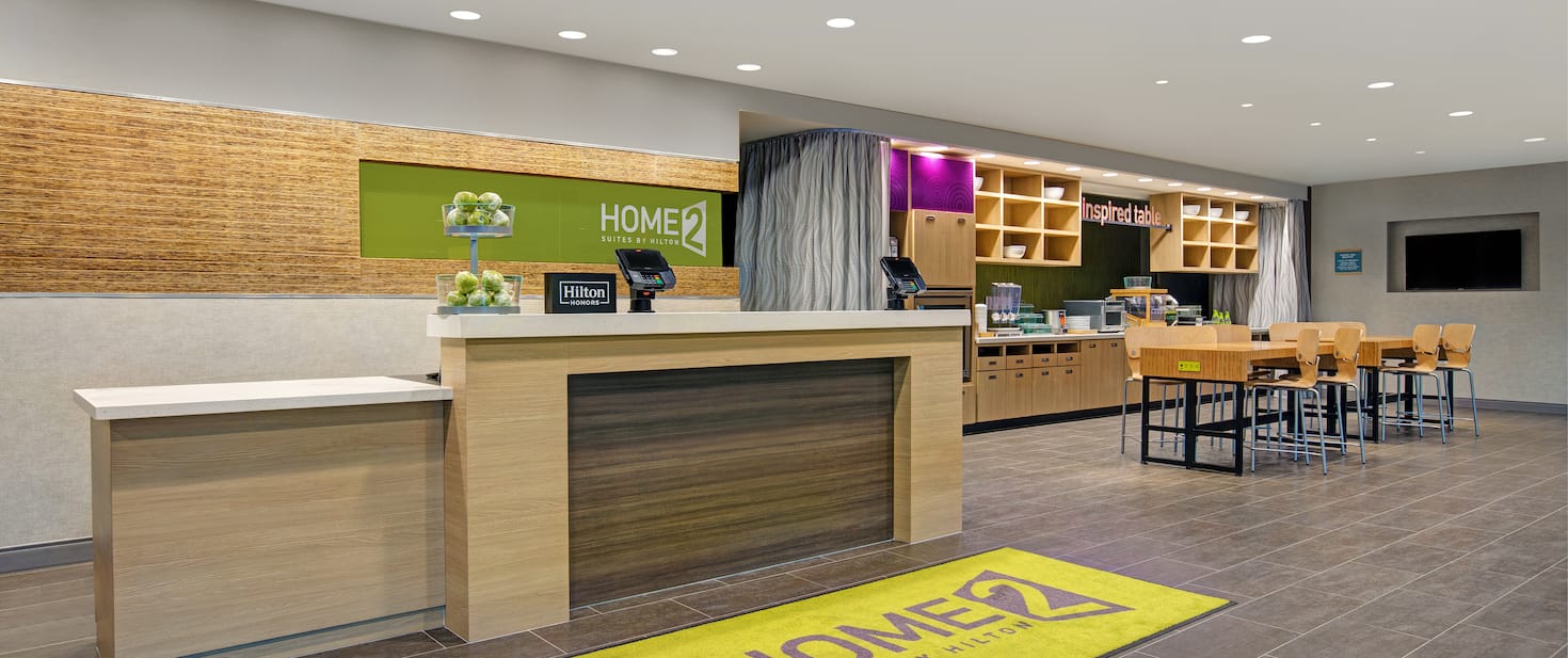 view of the hotel lobby showing kitchen area with a table and chairs