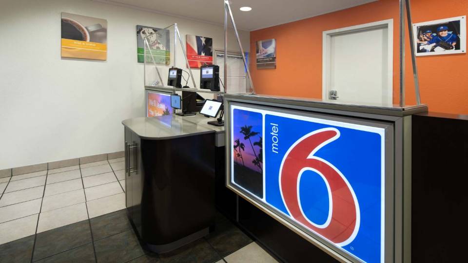 Hotel lobby view with a sign of the Motel 6 Logo