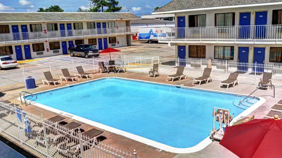 View to the pool area with lounge chairs surrounding the pool