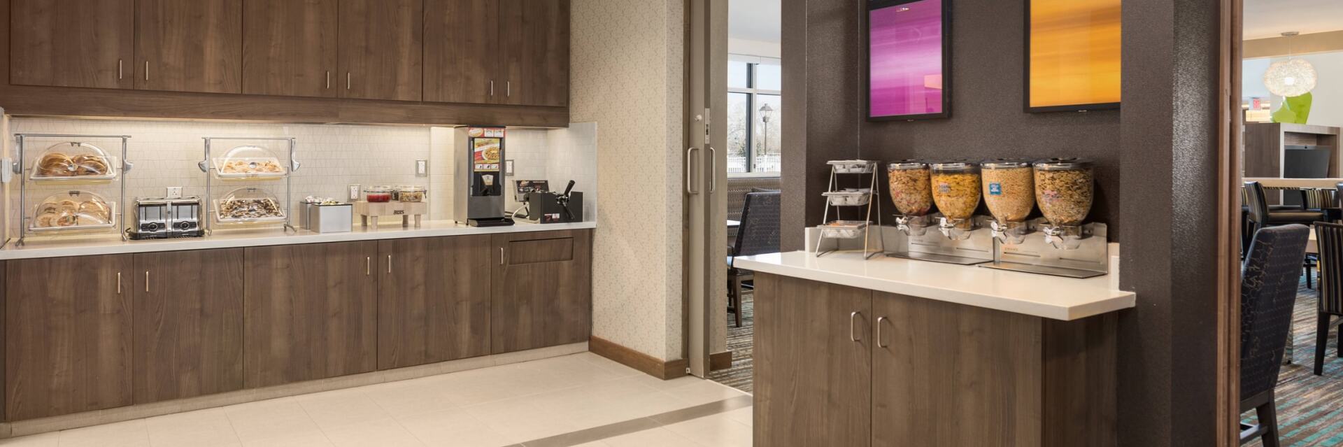 hotel breakfast room with multiple cereal options