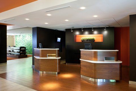 A hotel lobby with two wooden reception desks