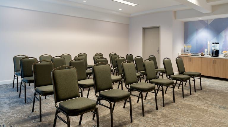 A row of chairs are lined up in a room.