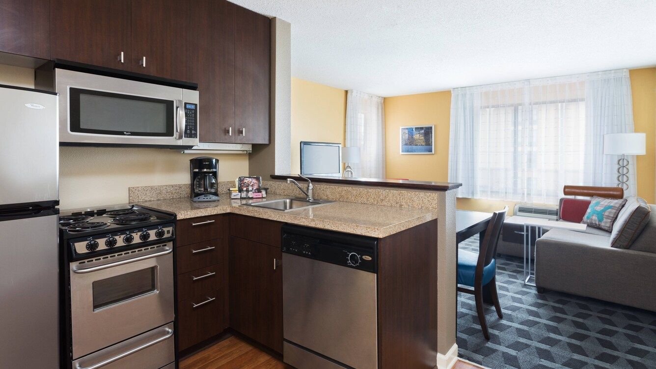 indoor hotel suite kitchen area view of microwave and fridge