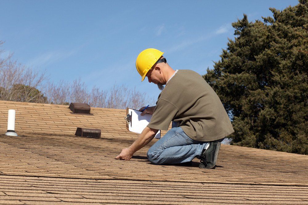 Man Checking House Roof — Lake Stevens, WA — Snohomish Valley Roofing