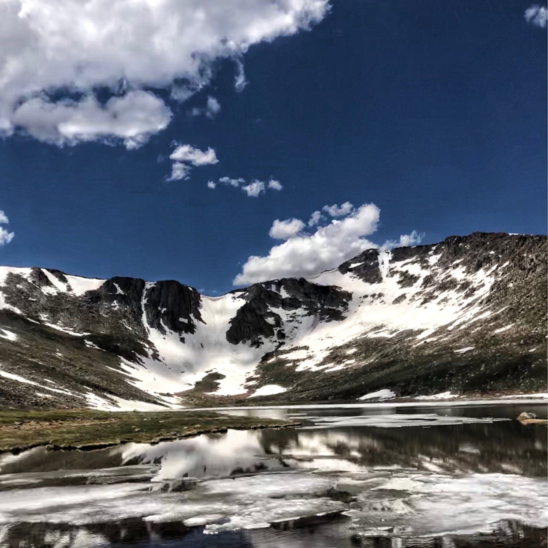 Mountain lake with snow on Mount Evans, Colorado.