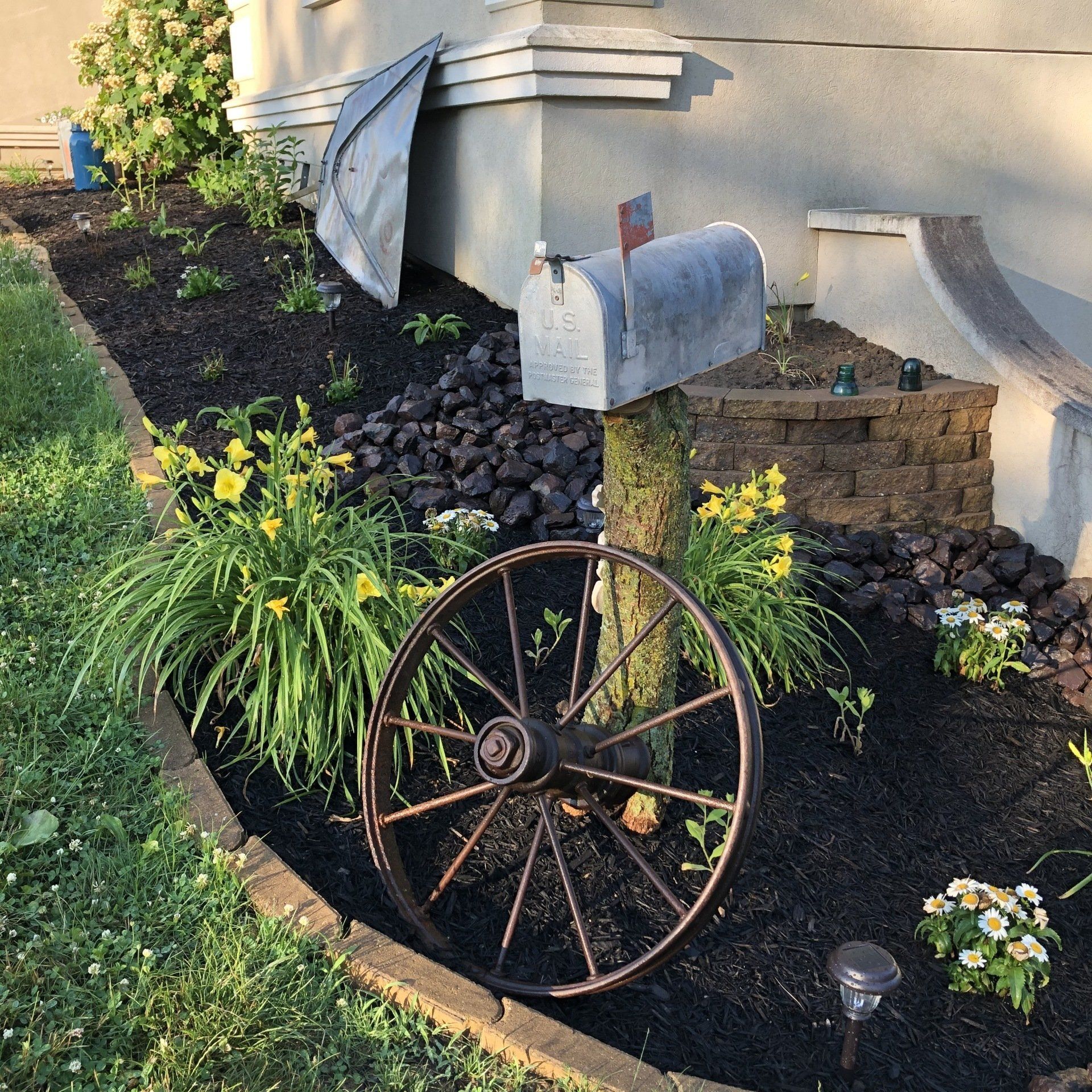 Old wheel from the Redd farm; mailbox from Linda Rees.