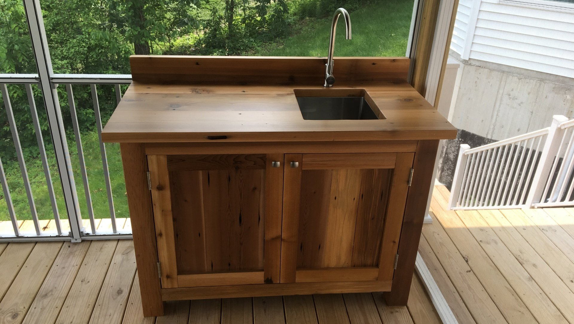 Custom cedar outdoor kitchen sink cabinet.