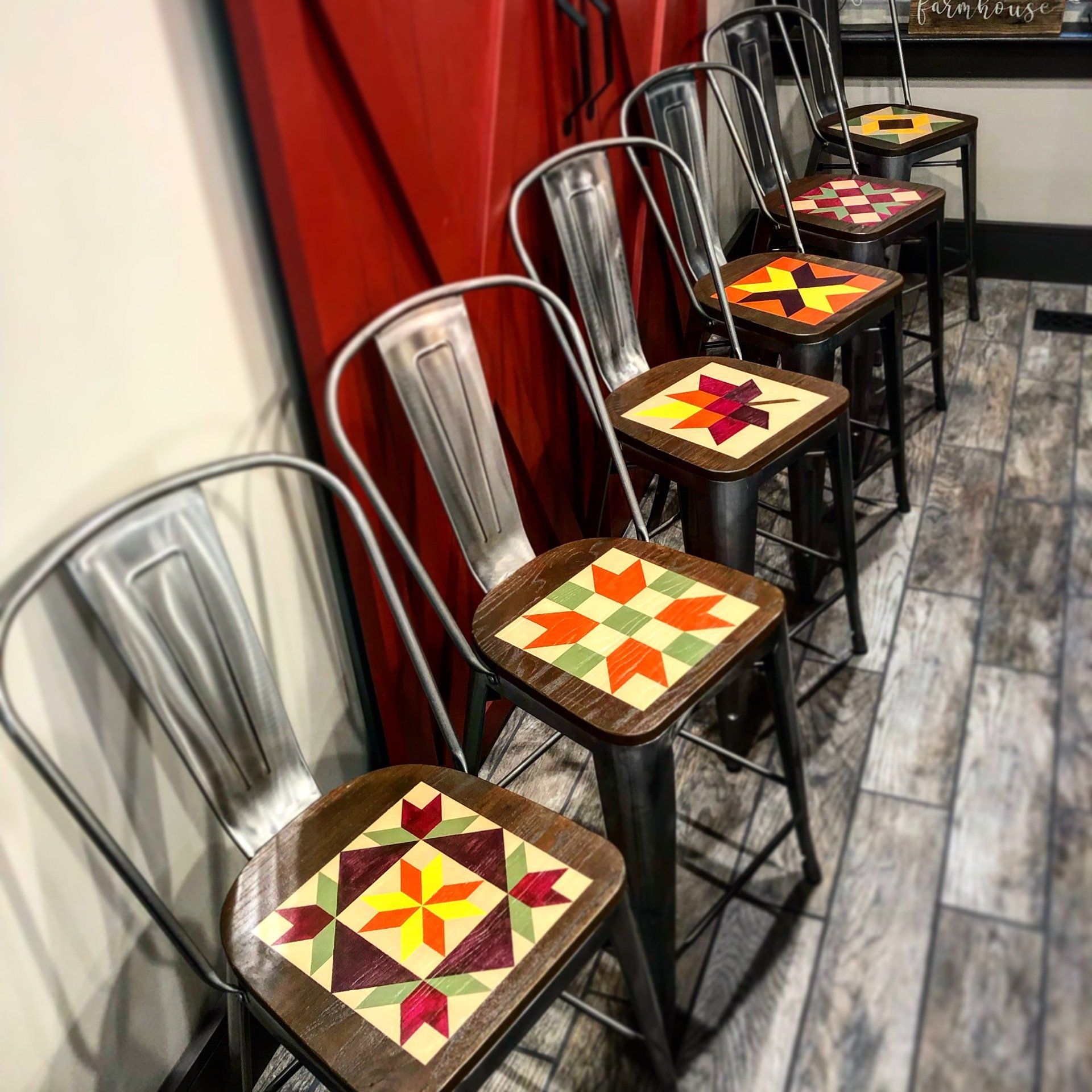 Six custom barn quilt chairs in the kitchen.