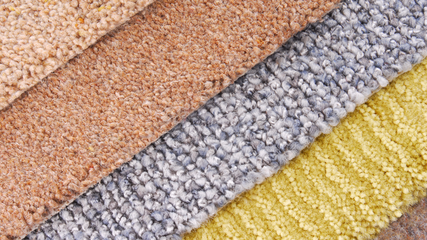 Carpet samples in various textures and colors: beige, brown, gray, and yellow.