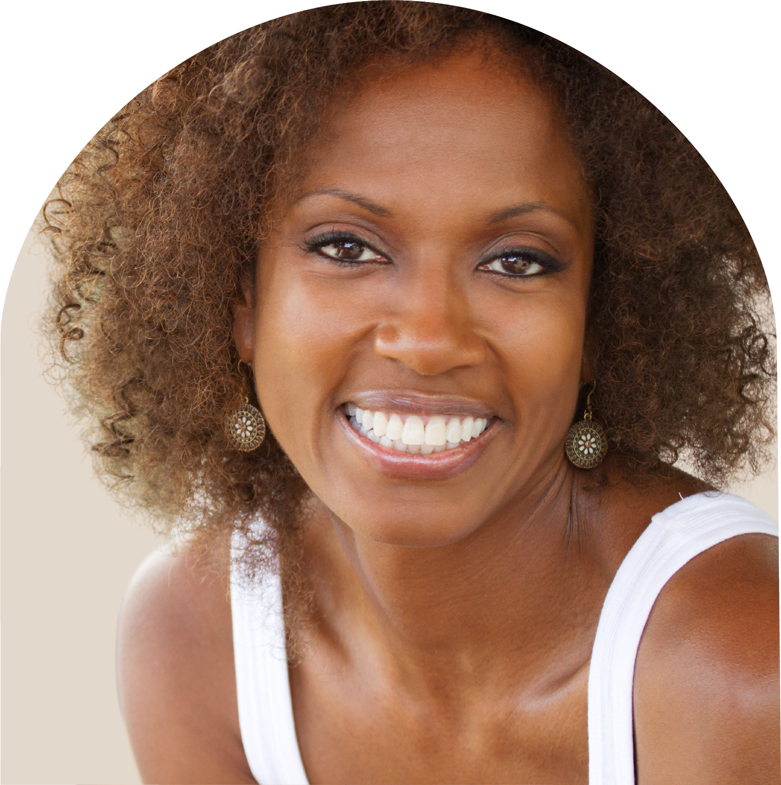 A woman in a white tank top smiles for the camera