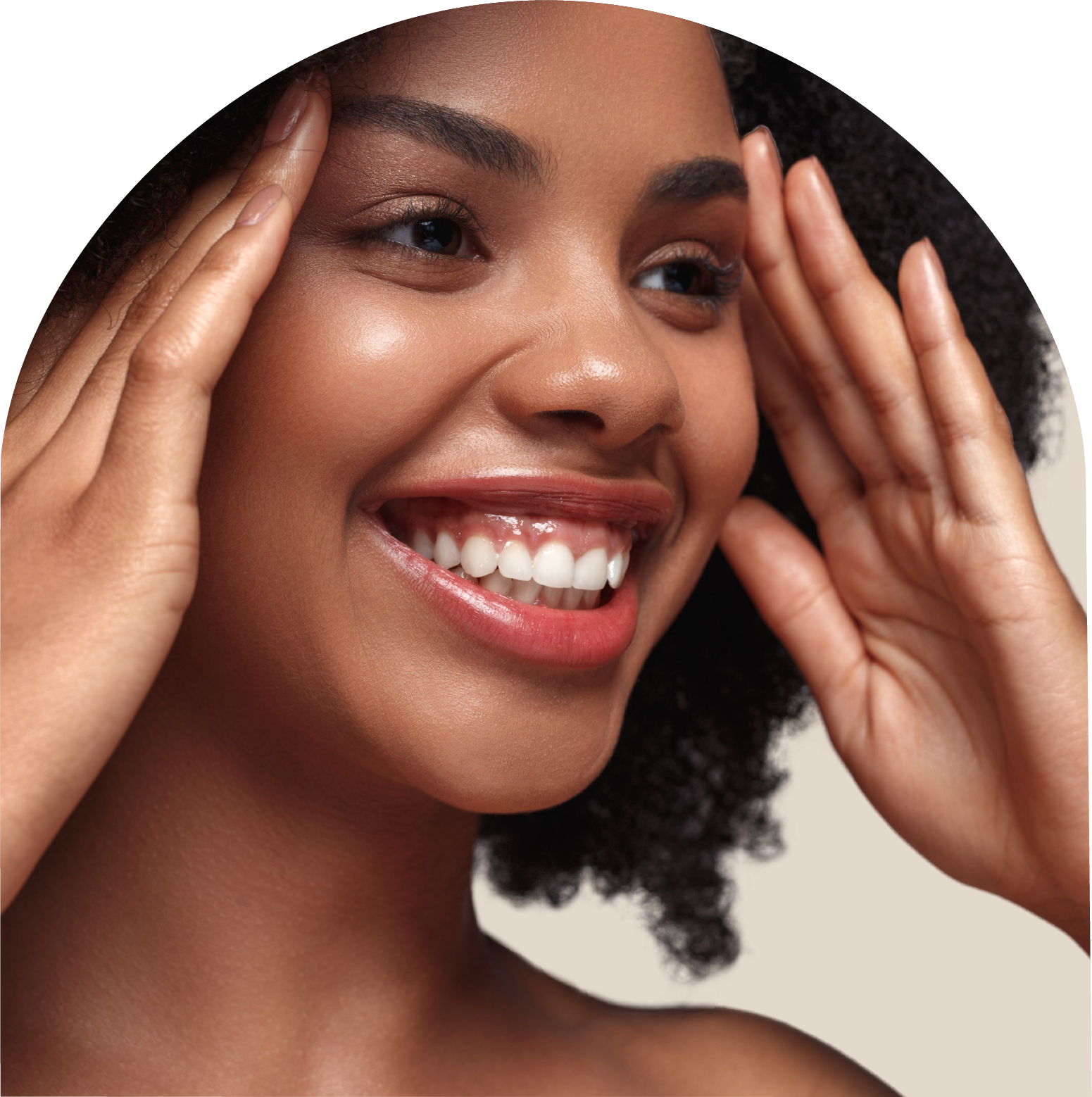 A woman is smiling and touching her face with her hands