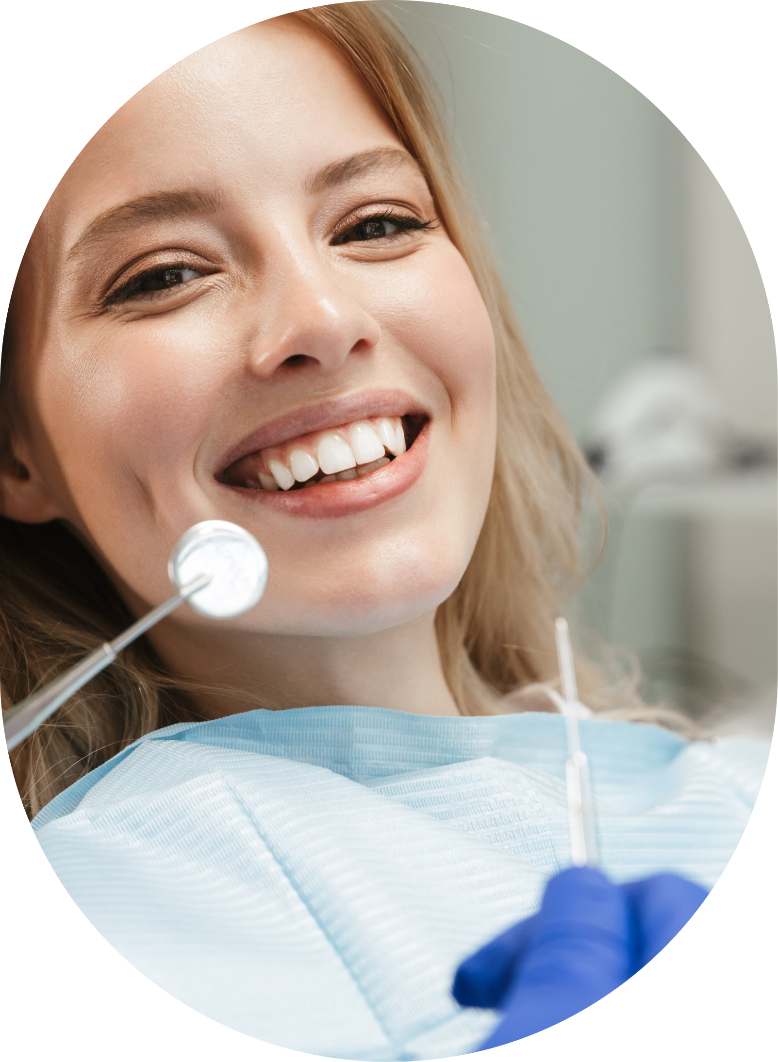 A woman is smiling while having her teeth examined by a dentist.