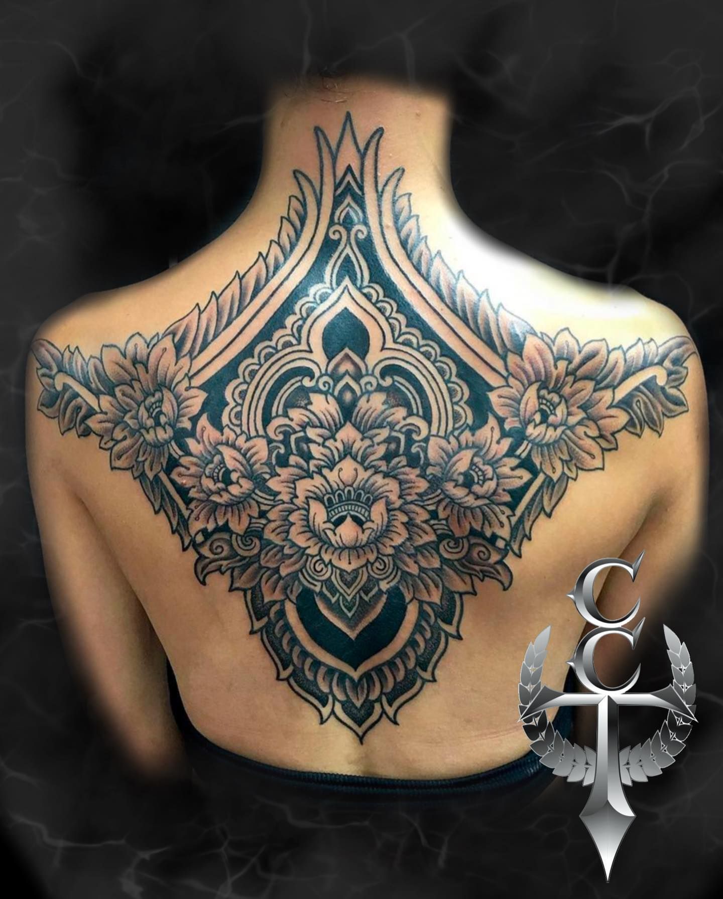 A Woman Has A Large Floral Tattoo On Her Back — Cairns City Tattoo In Cairns City, QLD