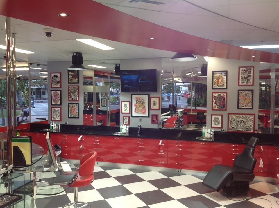 The Front Of A Tattoo And Body Piercing Shop With A Neon Sign — Cairns City Tattoo In Cairns City, QLD