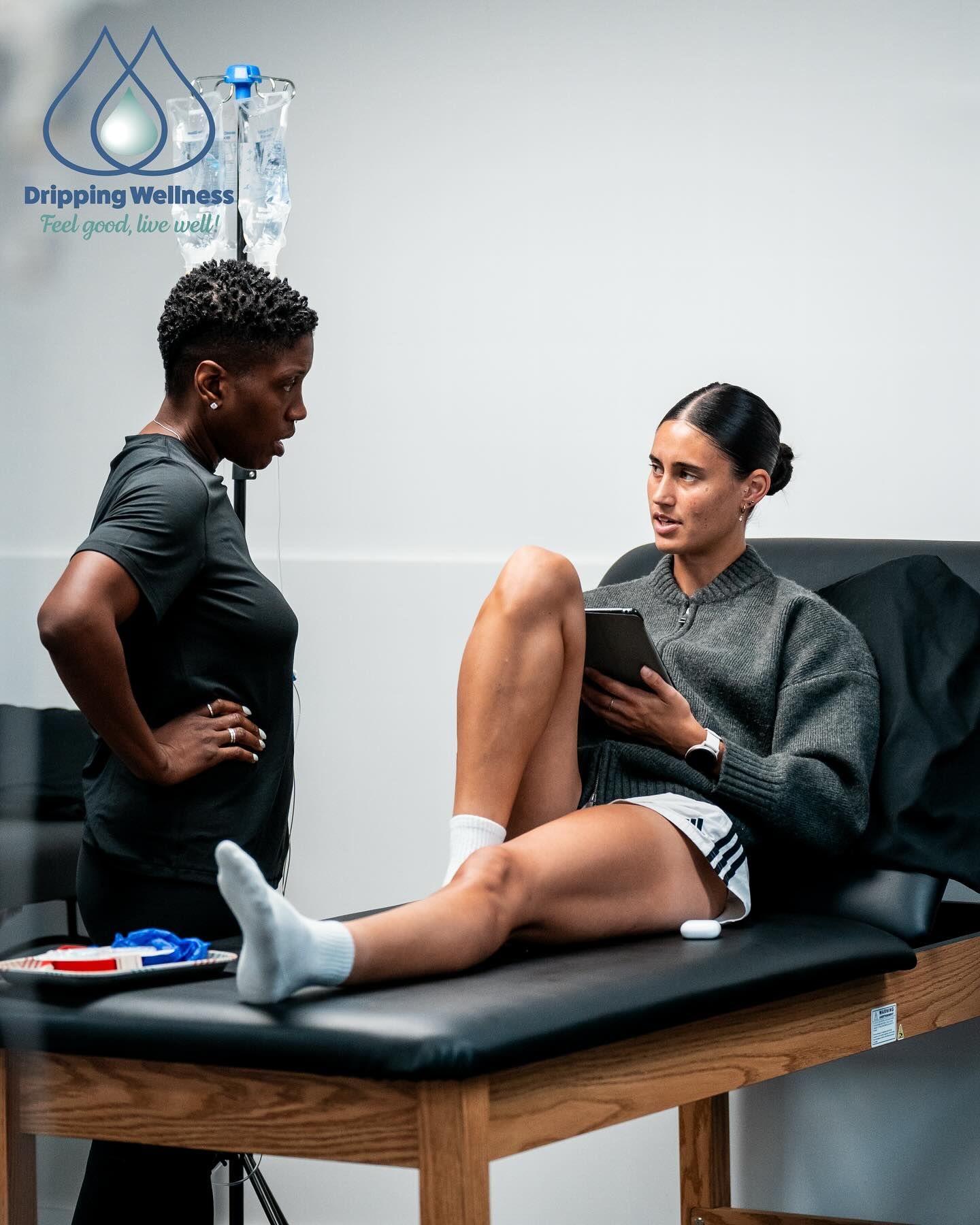 Woman on exam table speaking with CEO Faith Stample, LPN.