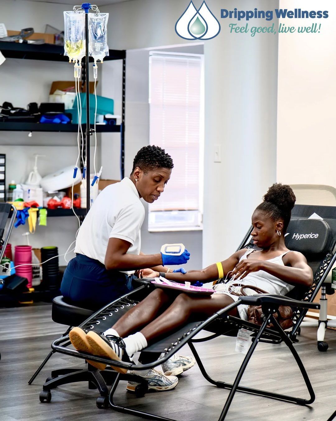 CEO Faith Stample, LPN administering an IV to a person seated in a reclining chair.