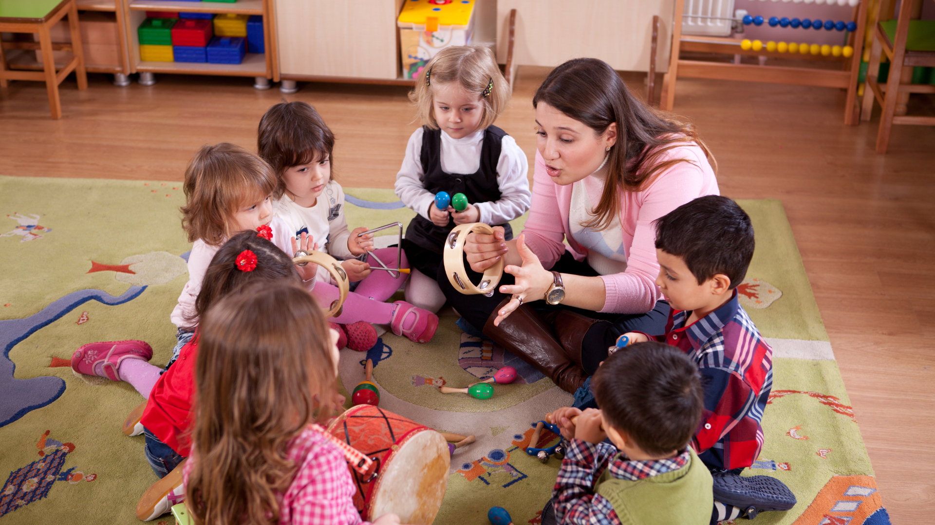 A woman is teaching a group of children how to play instruments.