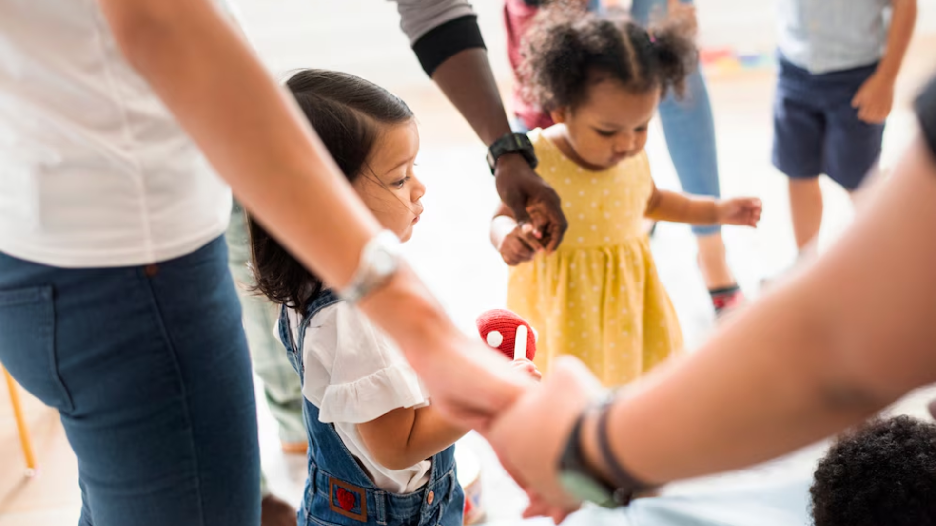 A group of children are holding hands in a circle.