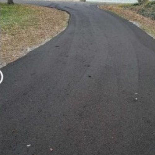 A person is riding a bike down a curvy road.