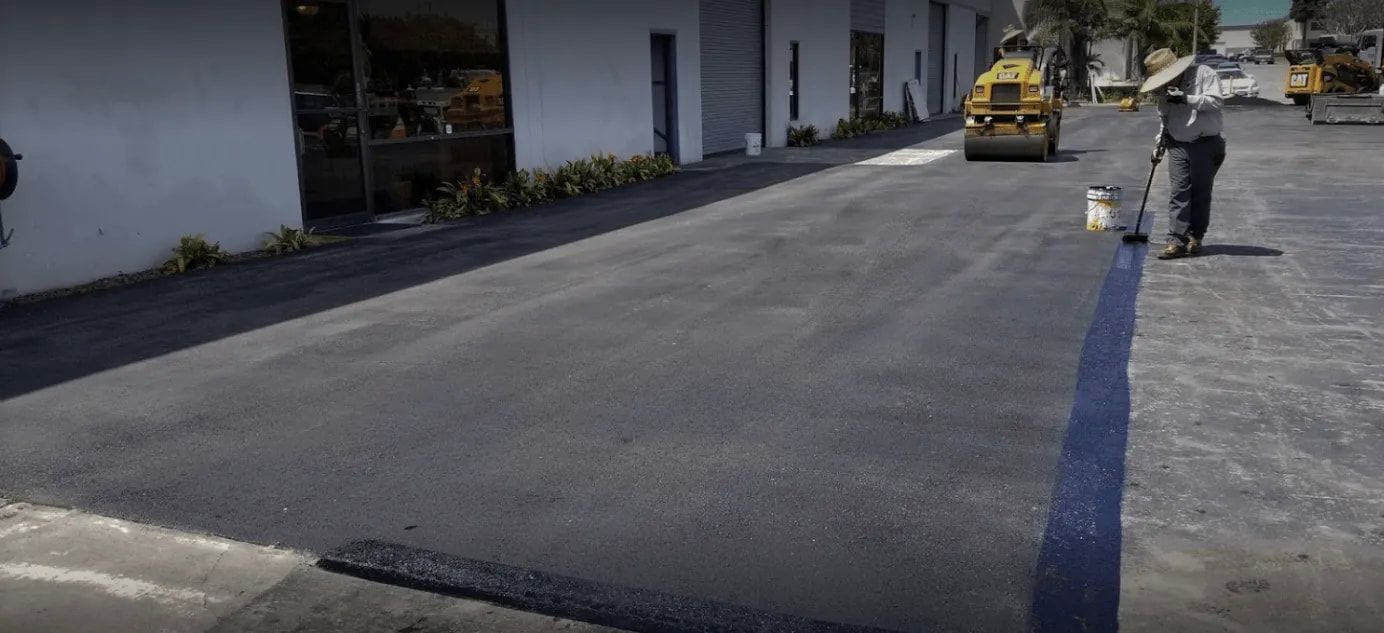 A man is walking down a street with a roller on it.