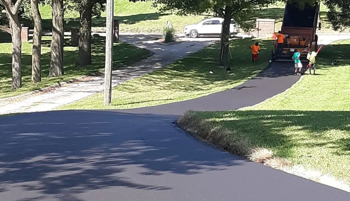 A group of people are walking down a road.