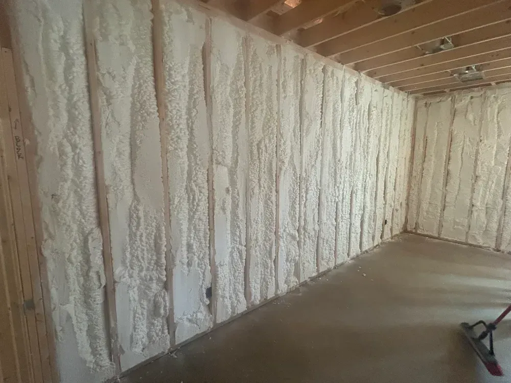 Spray foam insulation on interior walls of a room.