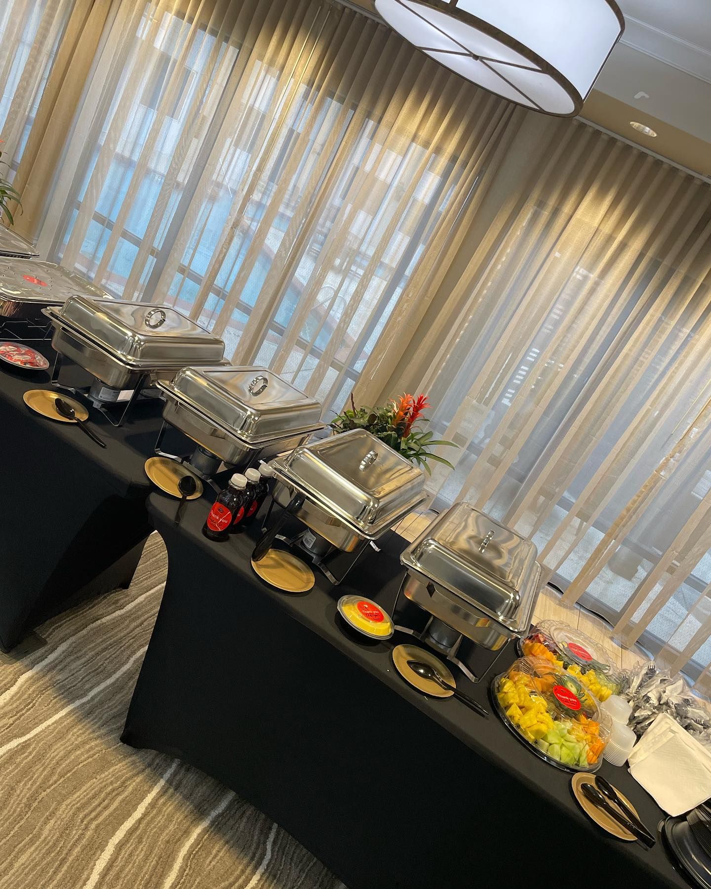 A buffet table with a lot of food on it in a room.