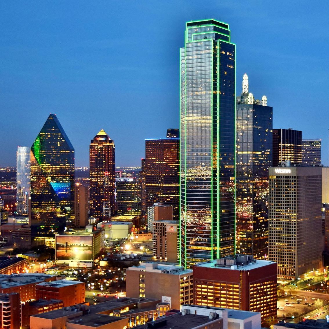 A woman is holding a child while a man looks on.