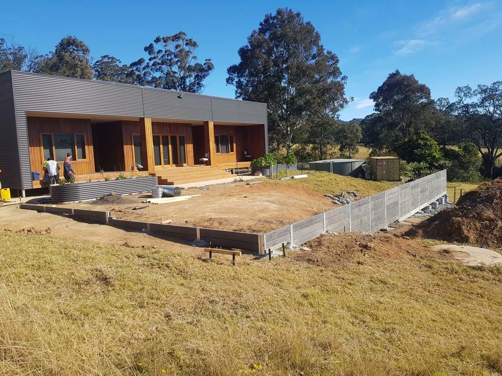 Rock Retaining Wall Installation — Wallaroo Landscapes In Nowra, NSW