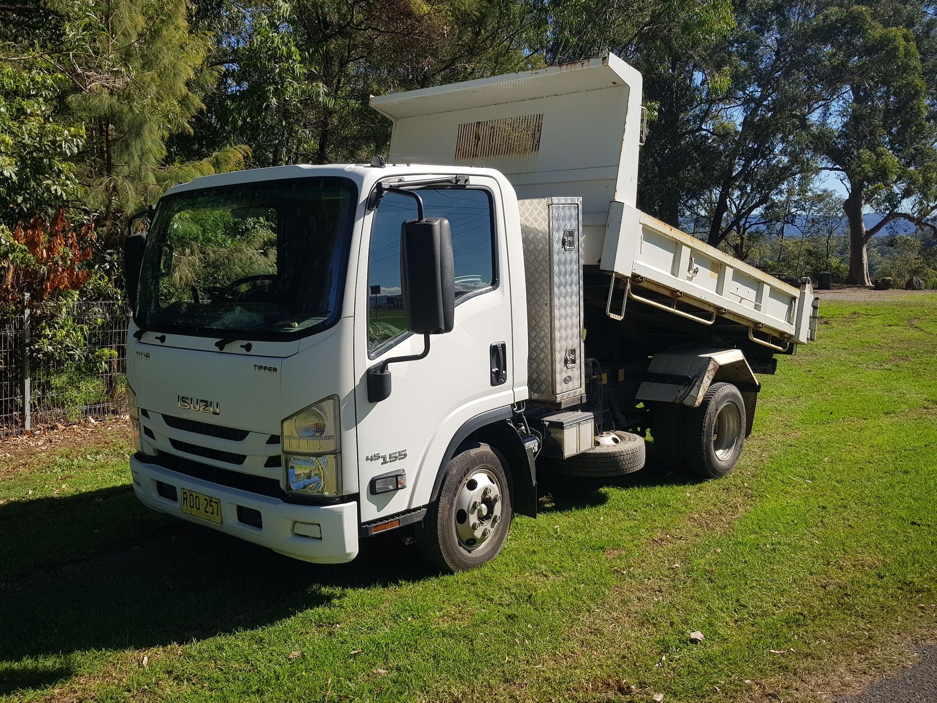 Excavator Loading Dumper Truck Tipper In Sand Pit Over Blue Sky — Wallaroo Landscapes In Nowra NSW
