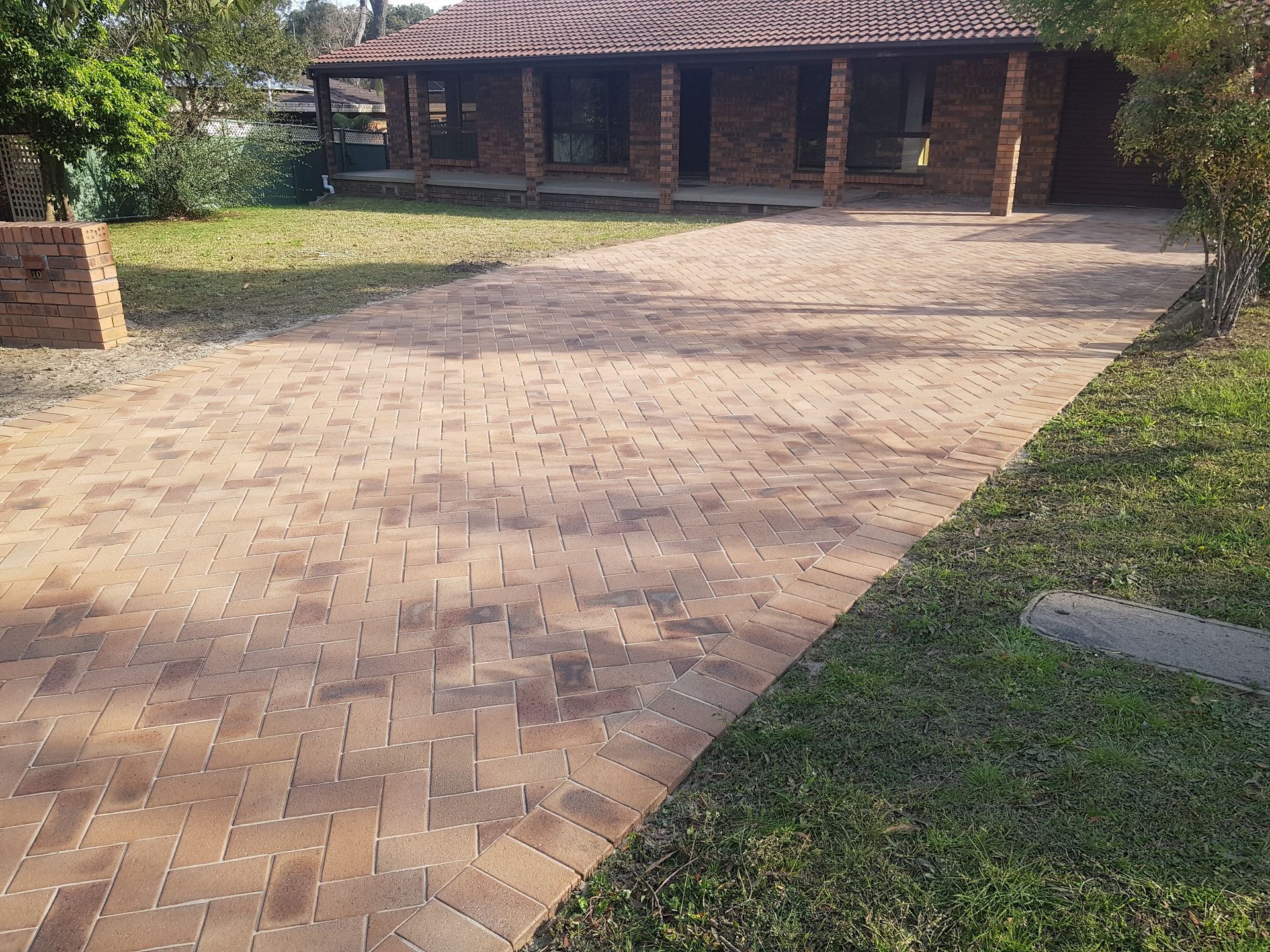 Nested Stone Pavers Of Various Colours Around The Grass — Wallaroo Landscapes In Nowra NSW
