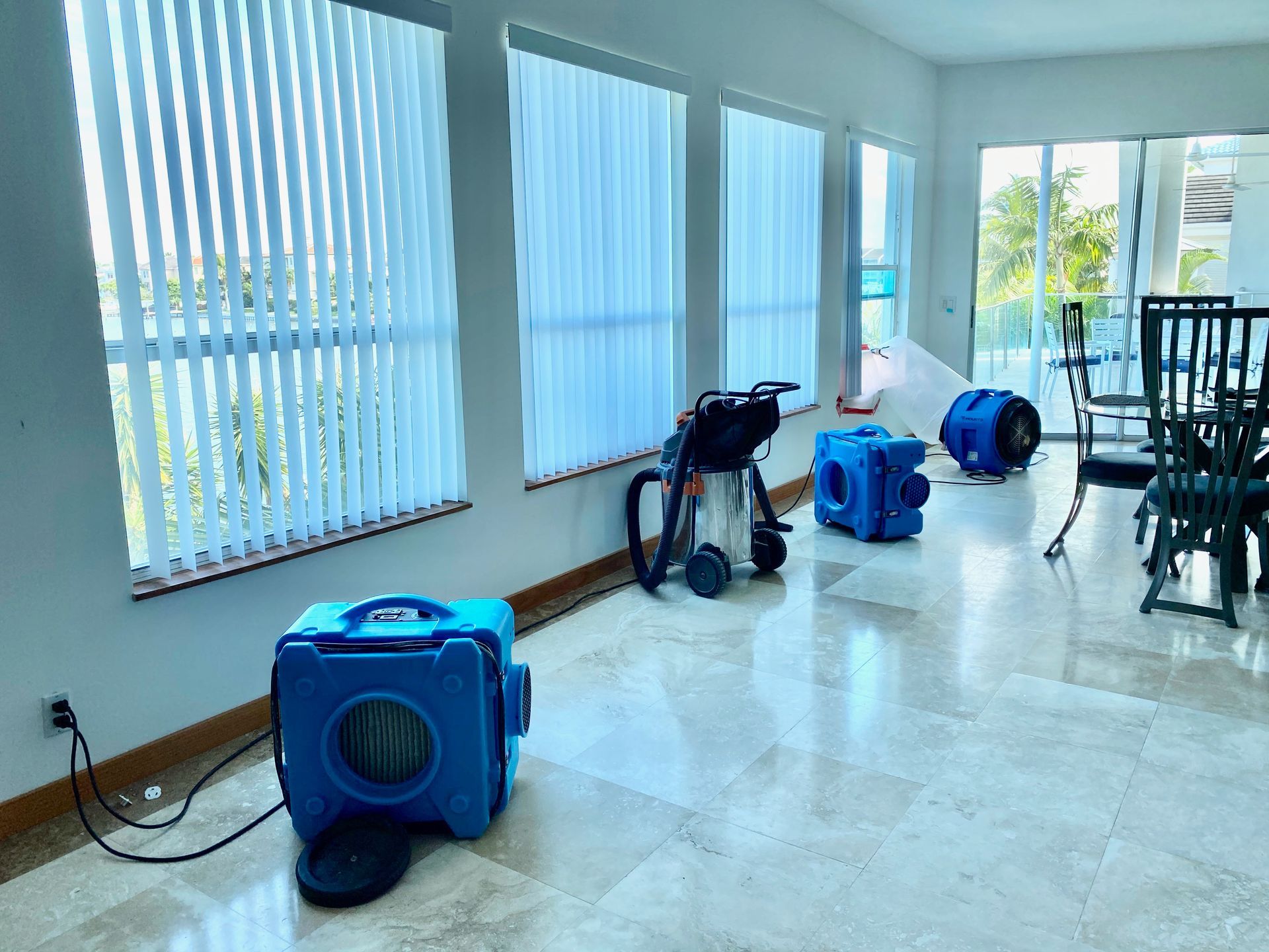 A living room filled with lots of windows and appliances.