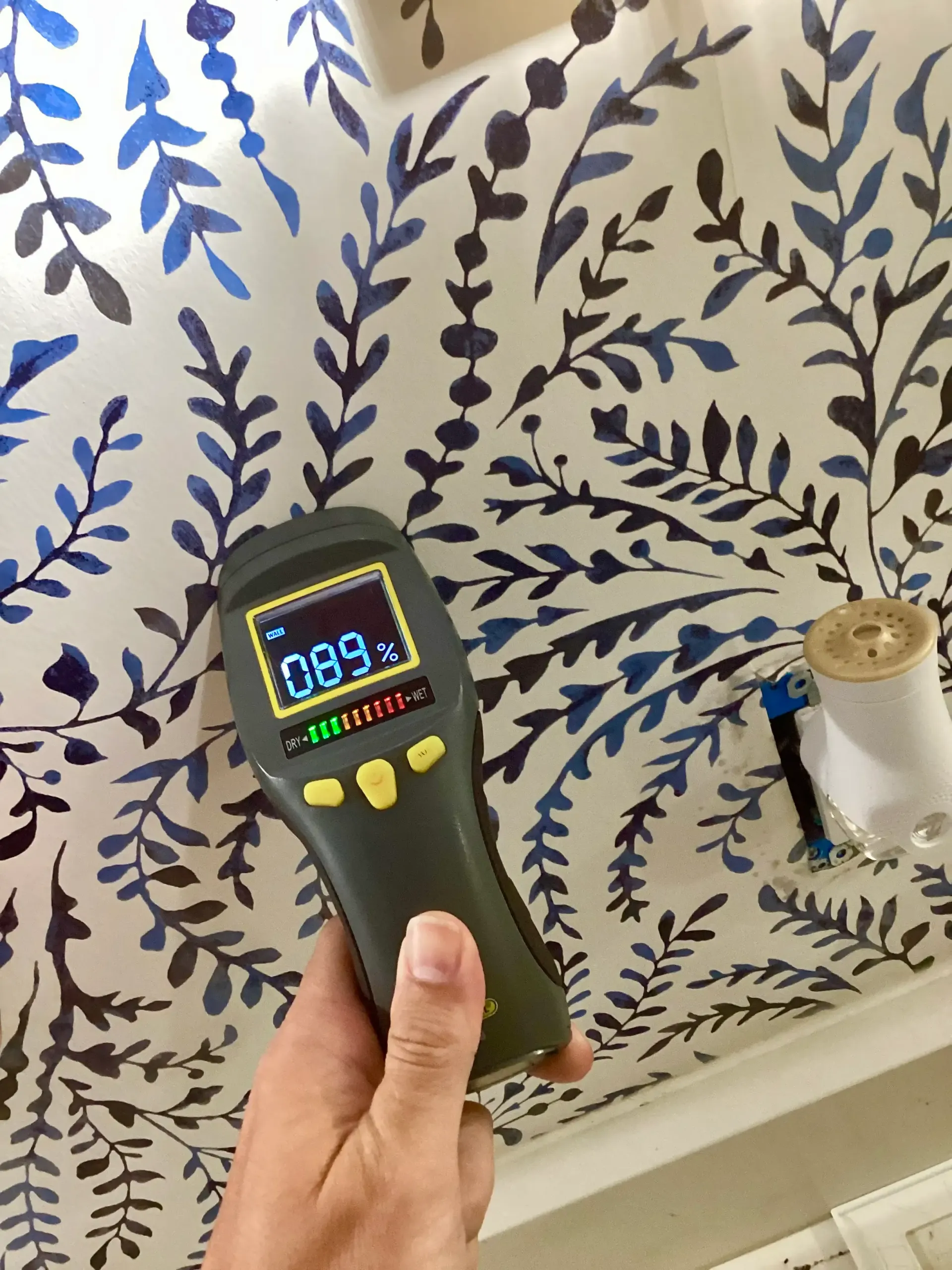 water damage to wall with wallpaper