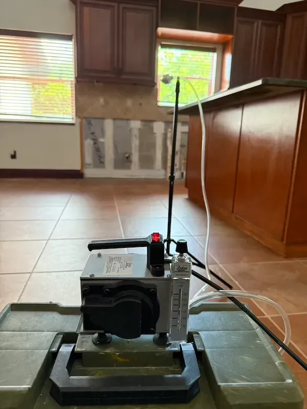 Taking an air sample for clearance testing after a remediation