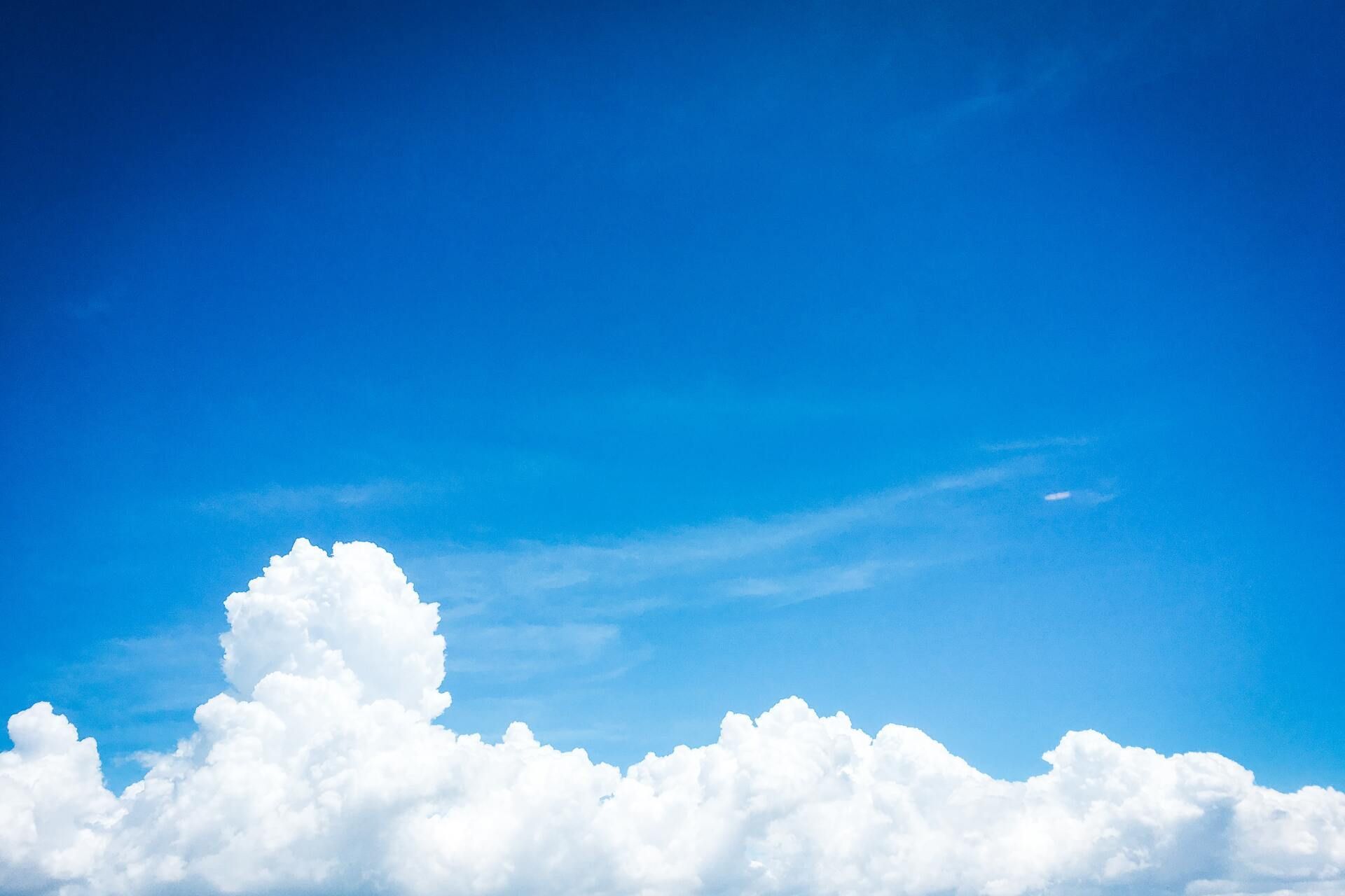 a blue sky with white clouds in it
