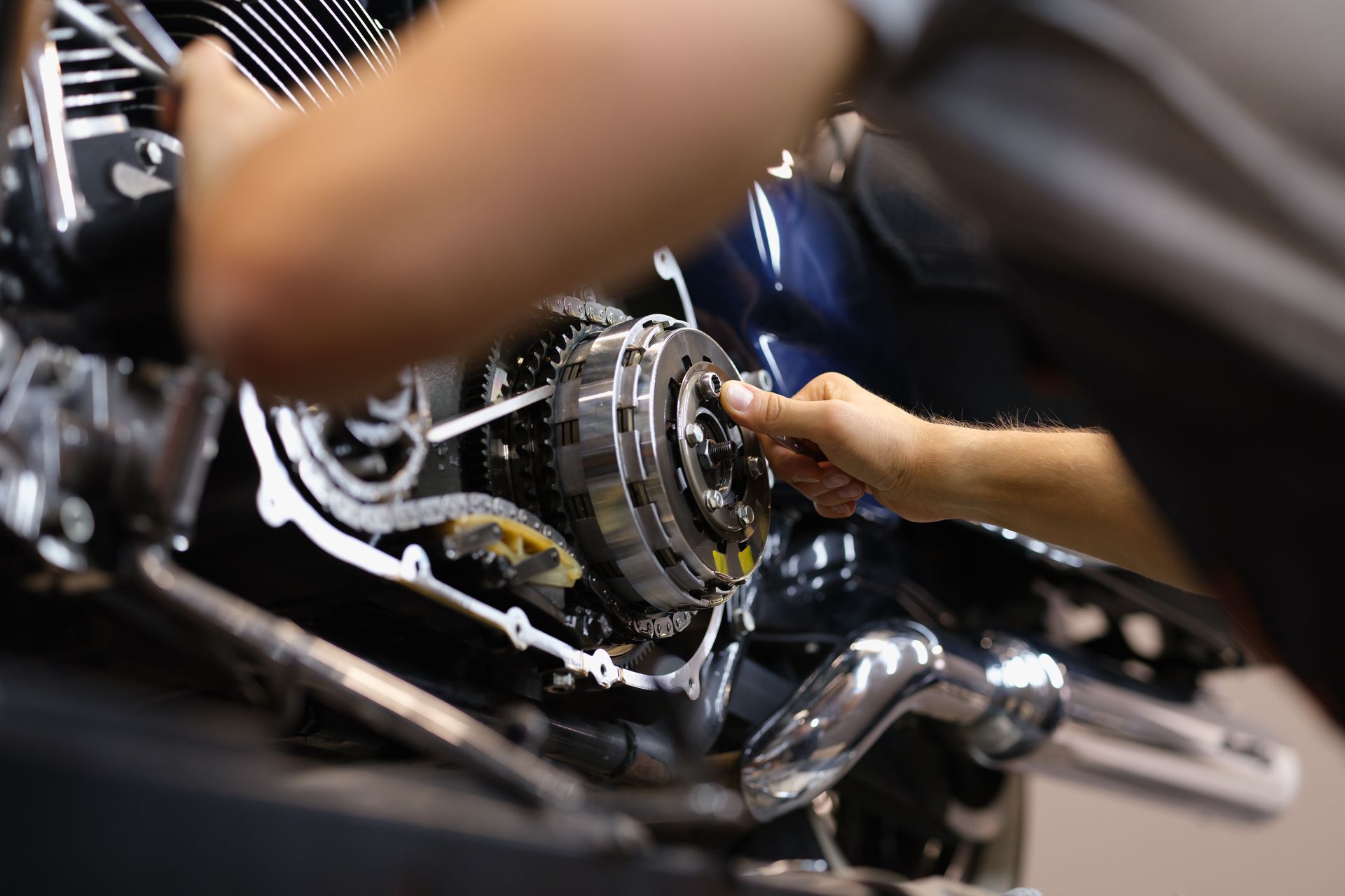 A mechanic is working on a motorcycle. 