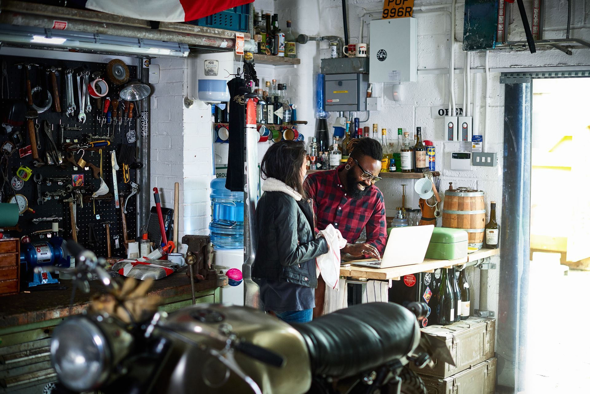 Picture of the owner and customer speaking at a motorcycle workshop. Picture of the owner and customer speaking at a motorcycle workshop.