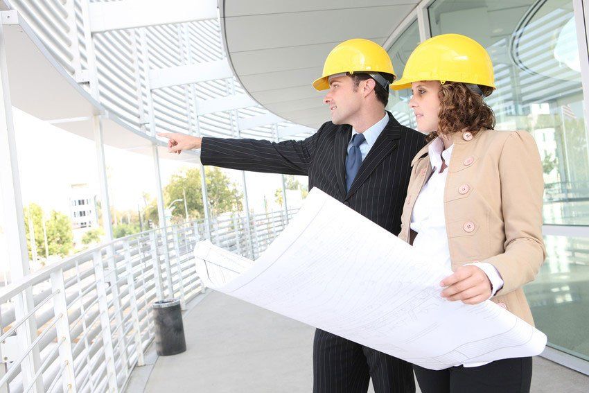 Man and woman architects on a building construction site