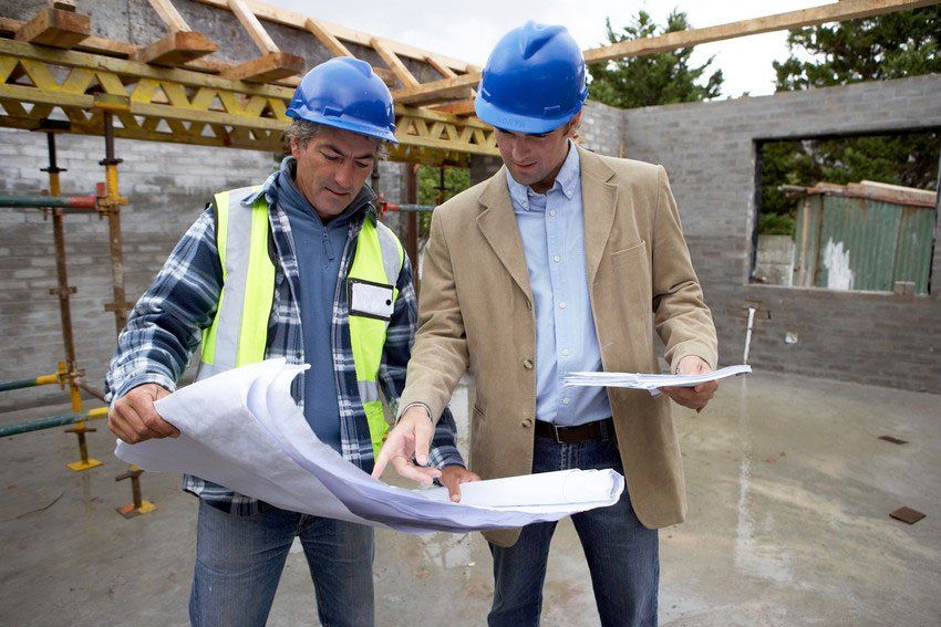 Two men in hard hats at construction site