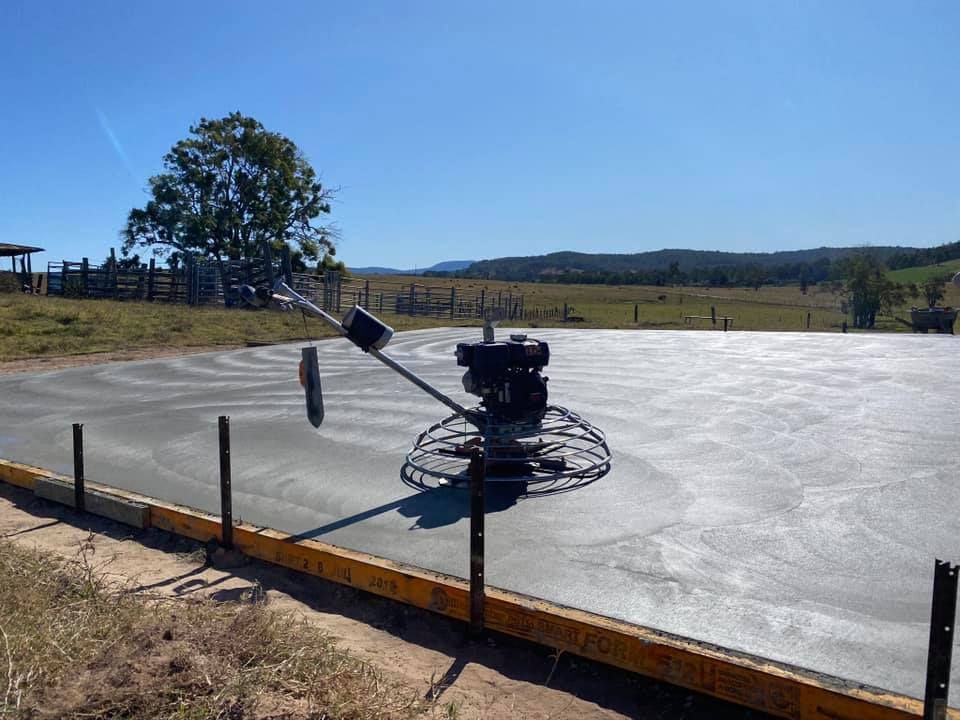 Power Trowel Smoothing a Large Concrete Slab on a Sunny Day — Wal's Concreting Service in North Casino, NSW