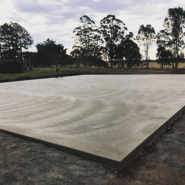 A large concrete slab with decorative concreting is poured on a field — Wal's Concreting Service in Ballina, NSW
