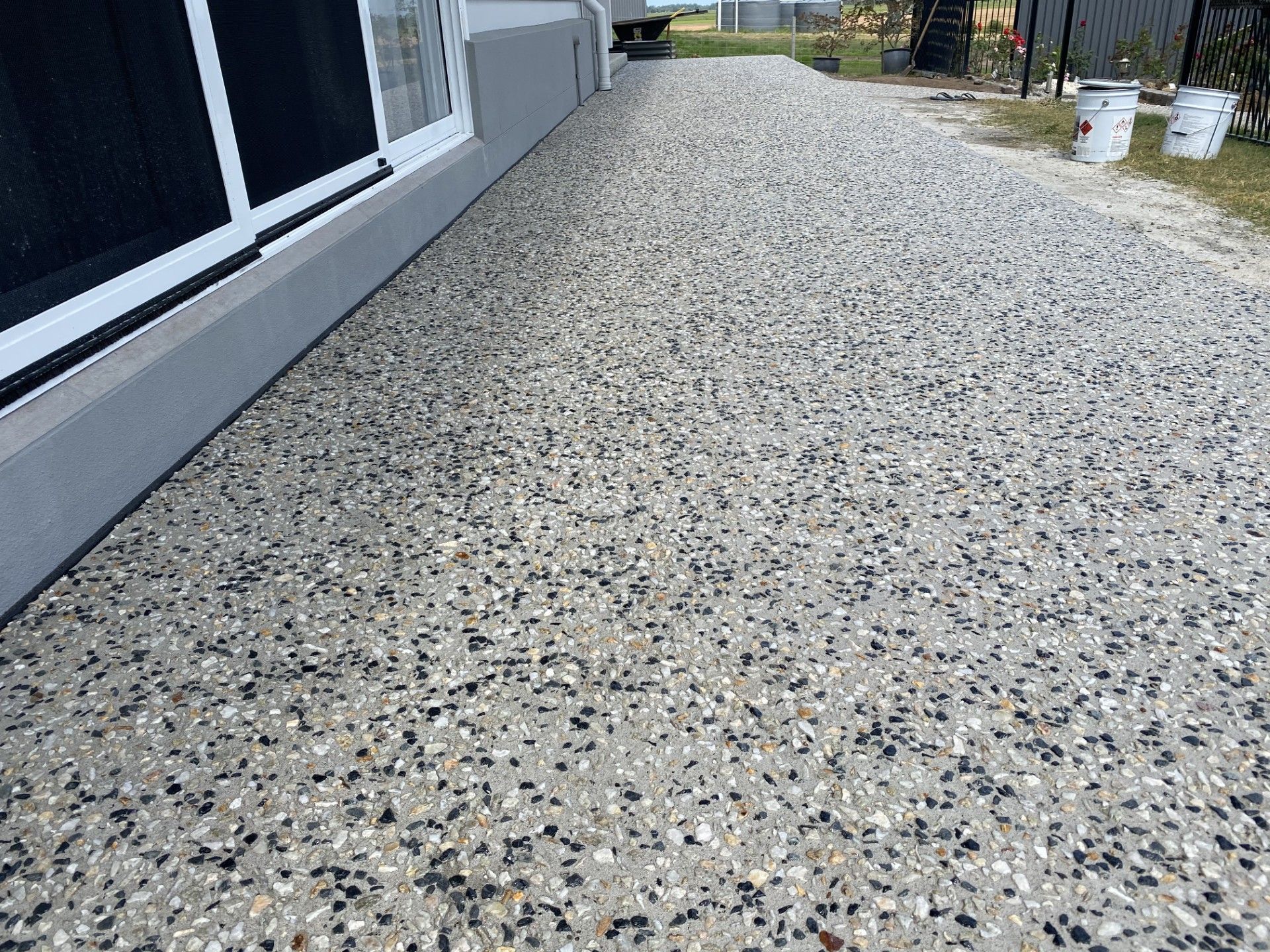 A large decorative path is surrounding a home — Wal's Concreting Service in Byron Bay, NSW