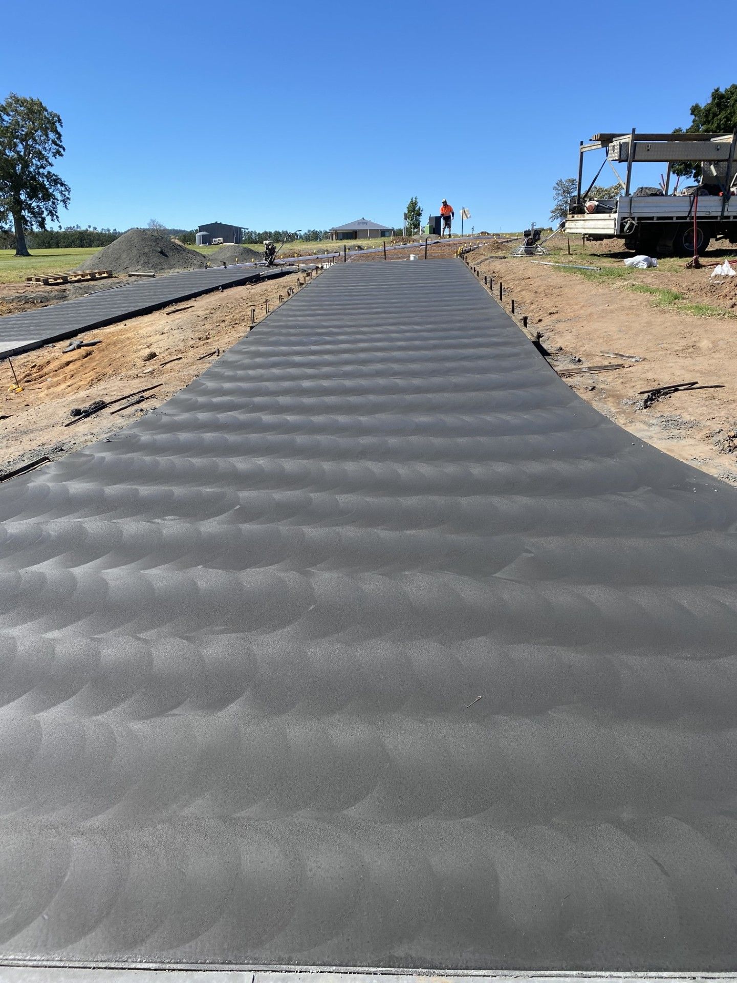 A large driveway is leading up a hill — Wal's Concreting Service in Ballina, NSW