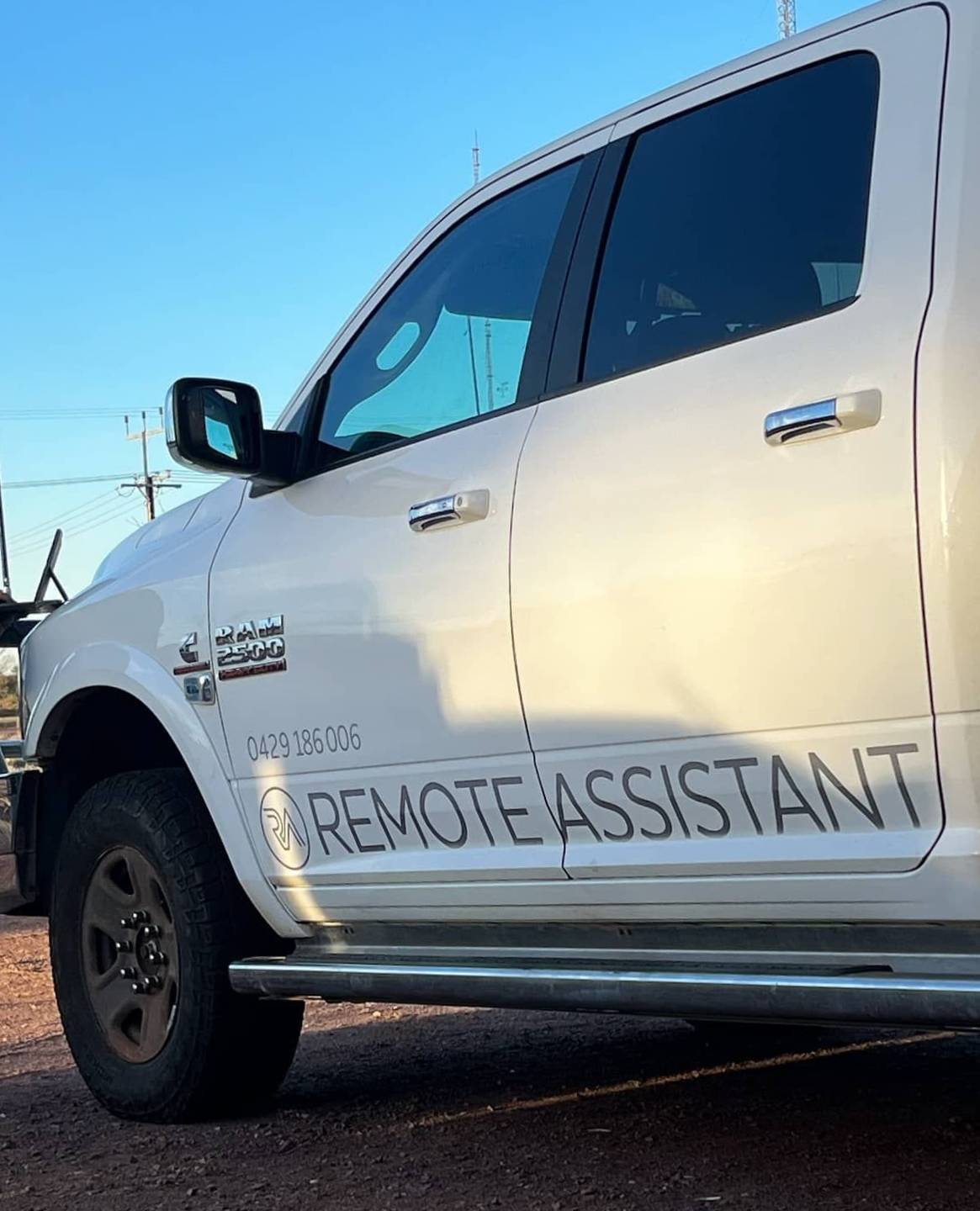 A Woman Is Standing Next To A Remote Assistant Truck — Remote Assistant In Braitling, NT
