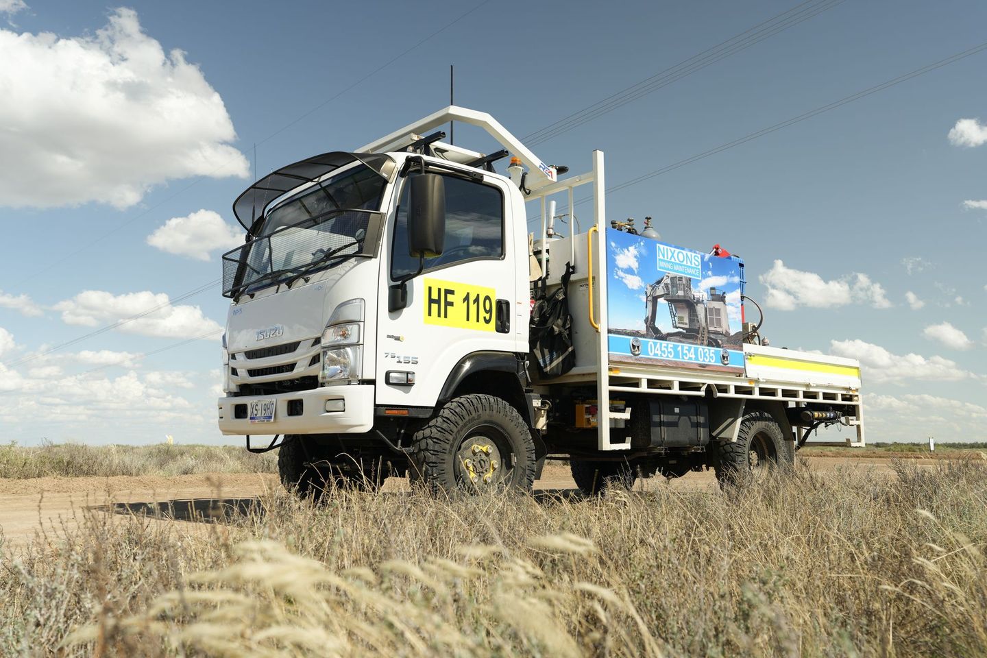 White truck, on a dry, grassy field under a cloudy sky — Remote Assistant In Braitling, NT