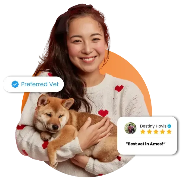 asian woman is smiling while holding dog, happy to be serviced by the best vet in ames ia