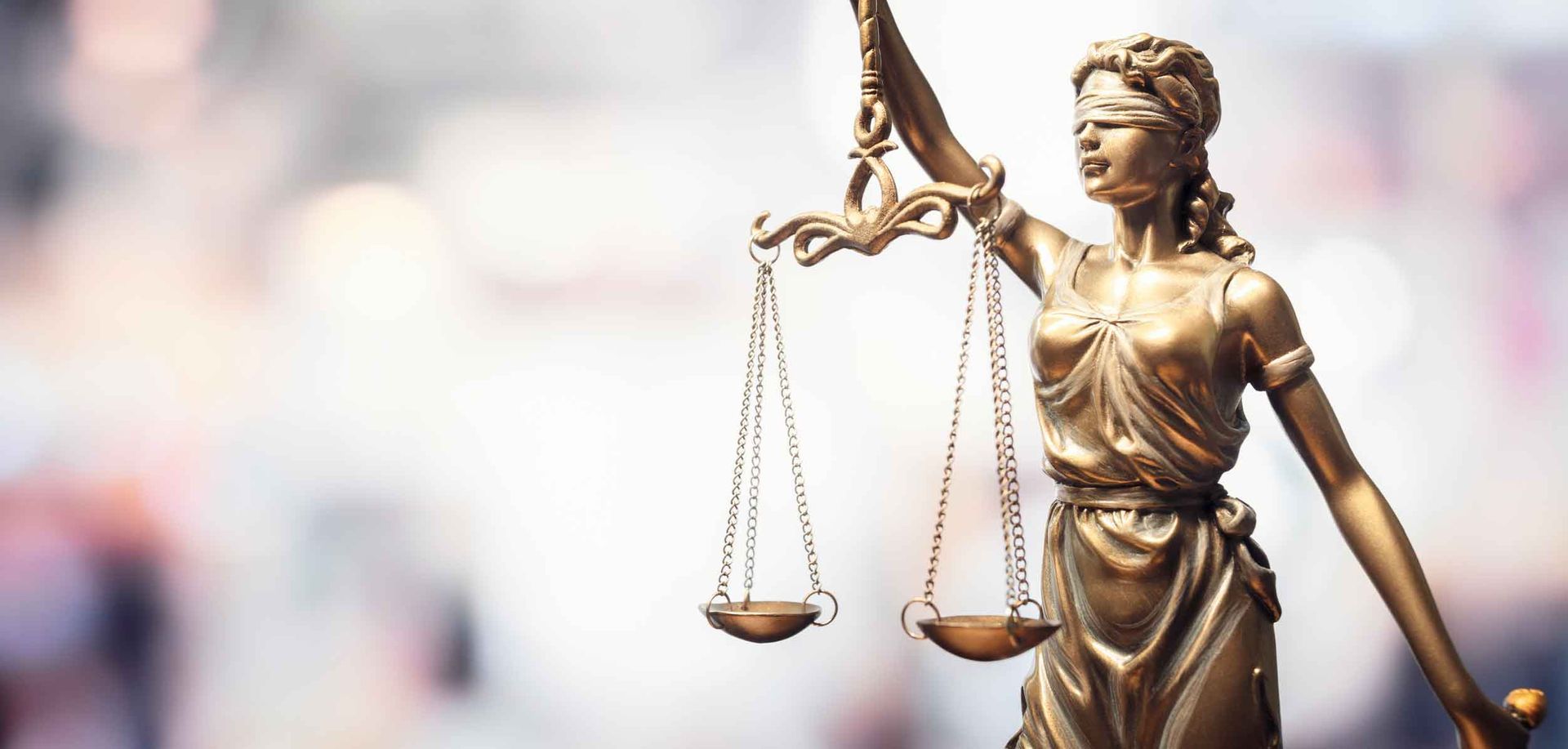 A statue of justice is holding a pair of scales.