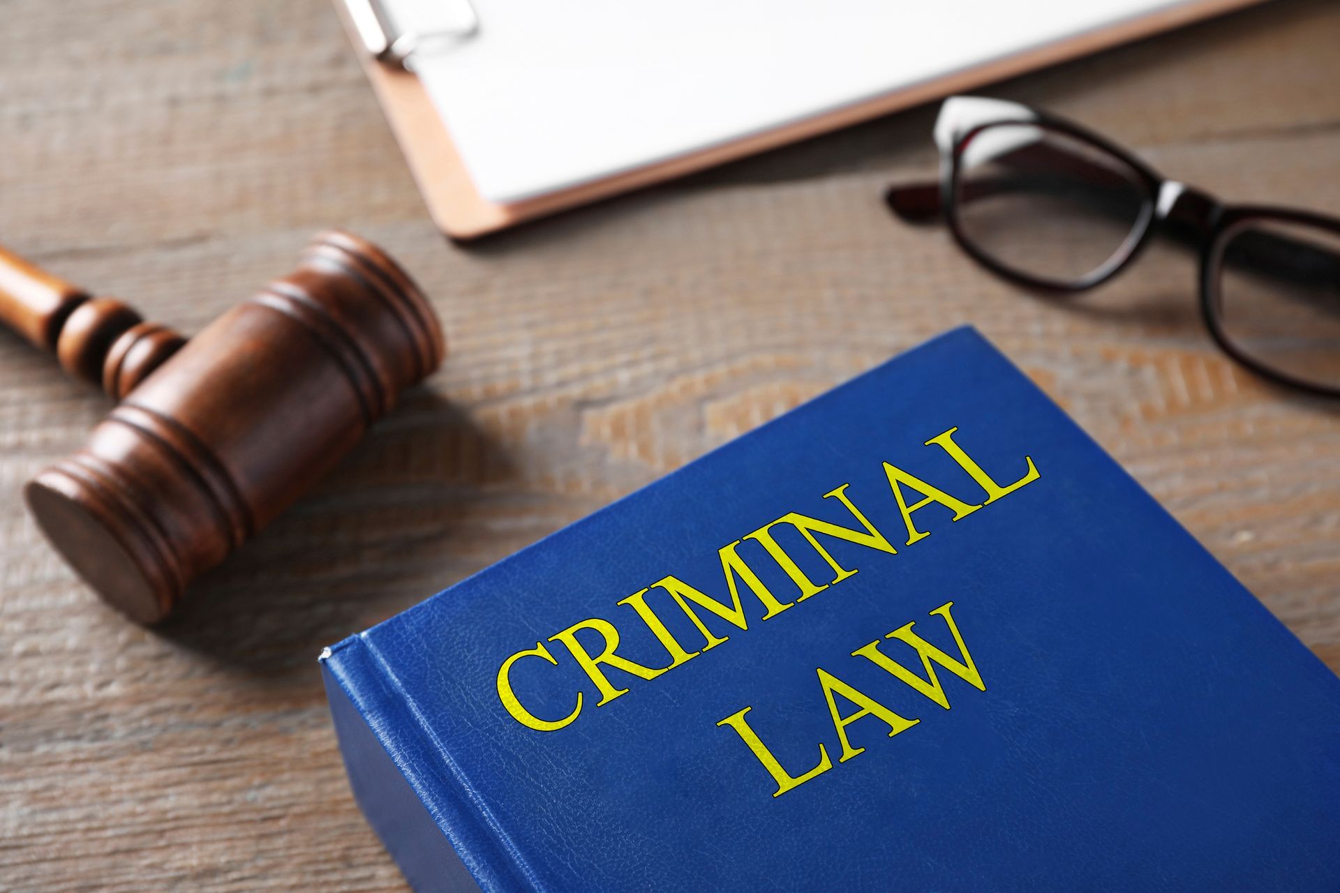 Gavel and book on wooden table. Criminal law concept