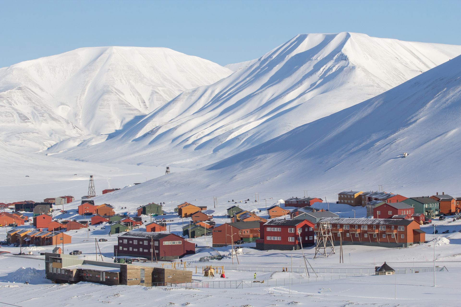 A snowy village with mountains in the background