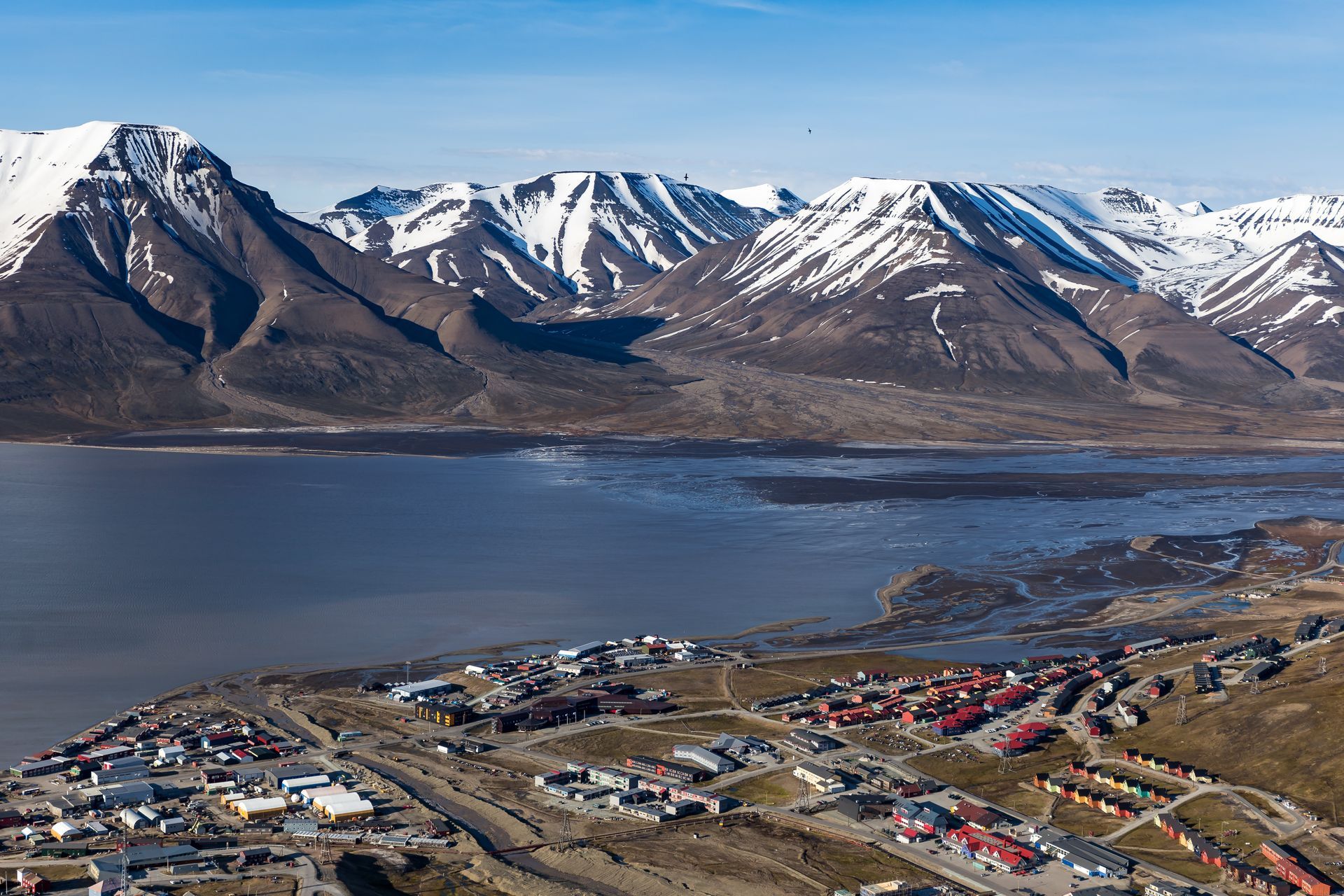 An aerial view of a city with mountains in the background
